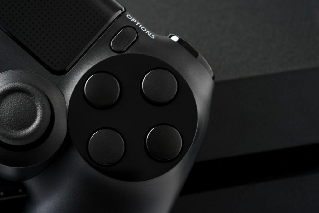 Close-up of a black game controller and its buttons