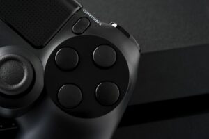 Close-up of a black game controller and its buttons